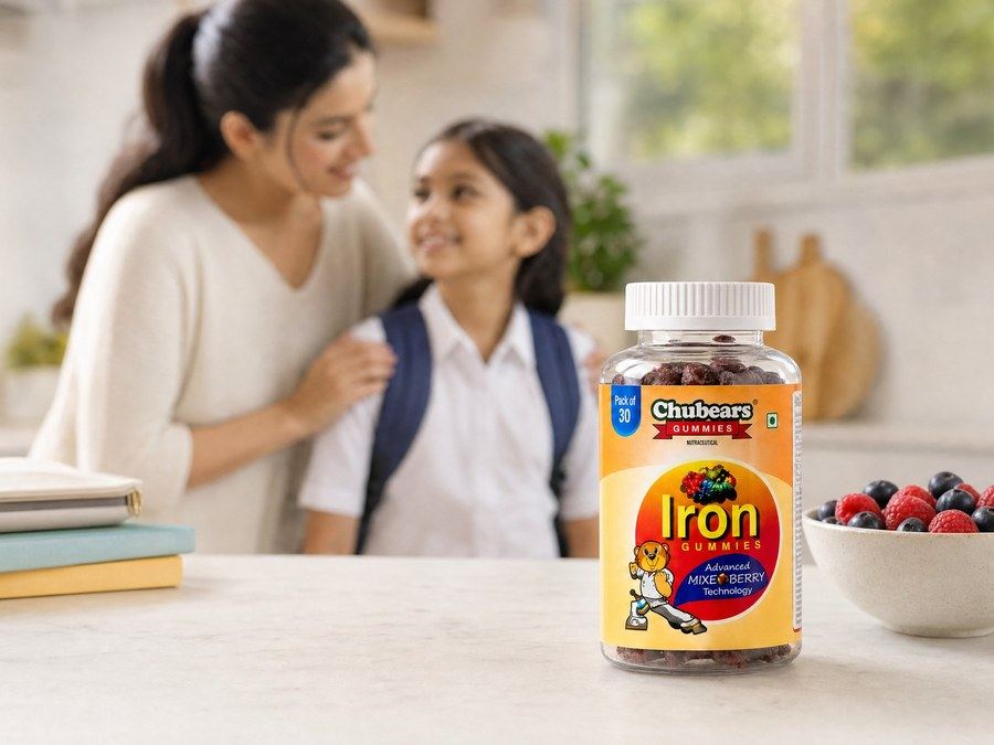 A mother and daughter at a kitchen table with a bottle of Chubears Iron gummies and a bowl of berries
